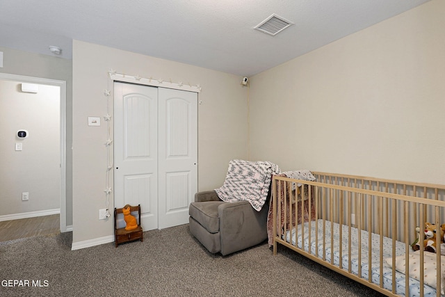 carpeted bedroom with baseboards, a closet, and visible vents