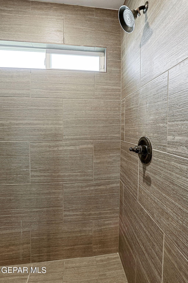 full bath with a tile shower