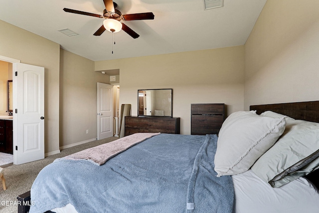 carpeted bedroom with a sink, baseboards, visible vents, and ceiling fan