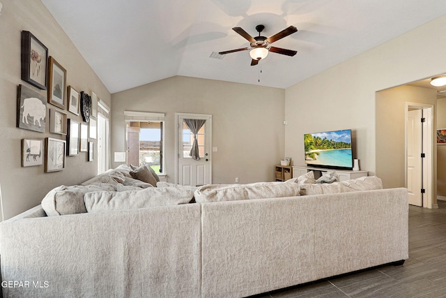 living area featuring ceiling fan, vaulted ceiling, dark wood-style floors, and visible vents