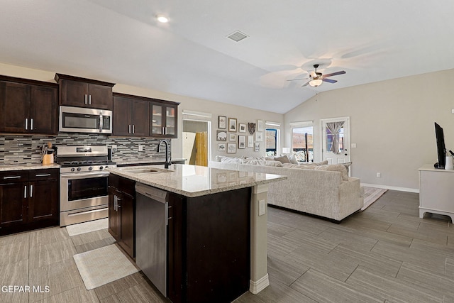 kitchen with backsplash, a ceiling fan, visible vents, appliances with stainless steel finishes, and a sink