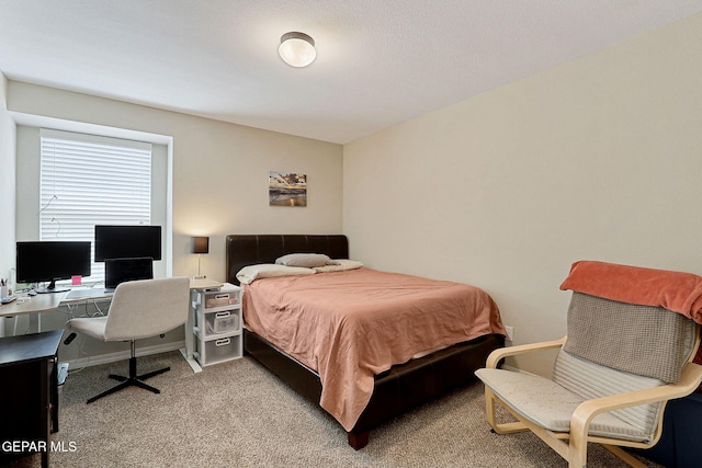 carpeted bedroom featuring baseboards