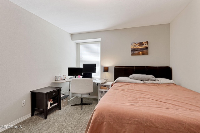 carpeted bedroom featuring baseboards