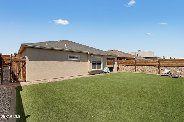 view of yard featuring a fenced backyard and a gate