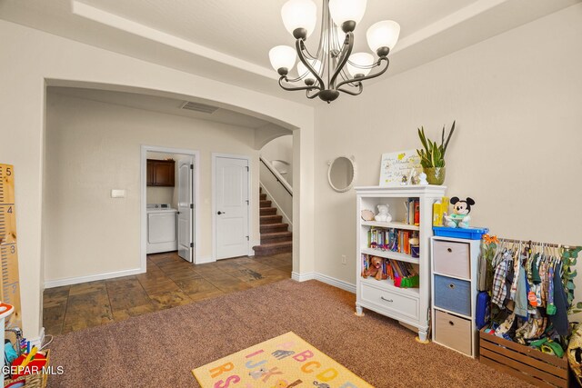 playroom with washer / dryer, arched walkways, baseboards, and a notable chandelier