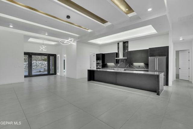 kitchen with a notable chandelier, a sink, light tile patterned floors, modern cabinets, and dark cabinets