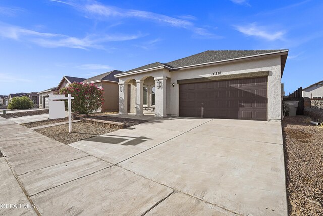 14218 Charles Pollock Ave, El Paso, TX 79938 - ranch-style house with driveway, an attached garage, and stucco siding