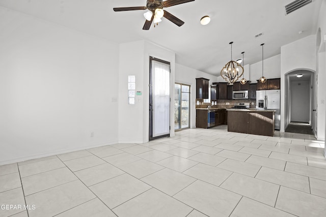 14218 Charles Pollock Ave, El Paso, TX 79938 - kitchen with stainless steel appliances, open floor plan, a ceiling fan, tasteful backsplash, and dark brown cabinets