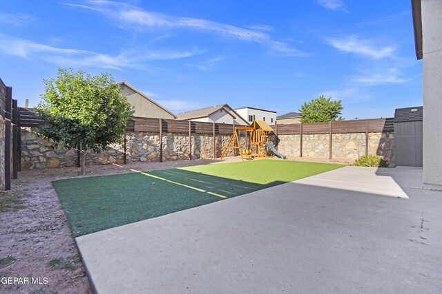 14218 Charles Pollock Ave, El Paso, TX 79938 - fenced backyard with a playground and a patio