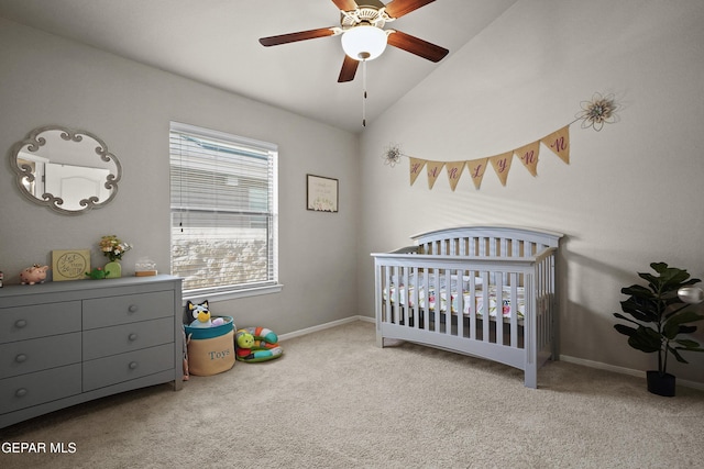 bedroom featuring a nursery area, carpet, lofted ceiling, and baseboards