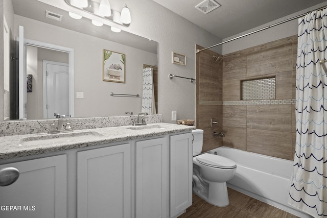 full bathroom featuring shower / tub combo with curtain, wood finished floors, double vanity, and toilet