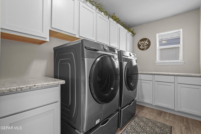 laundry room with cabinet space and washer and clothes dryer