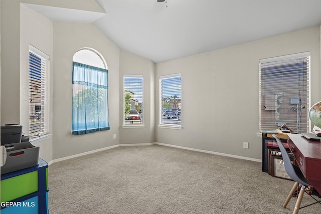 unfurnished office with carpet flooring, lofted ceiling, and baseboards