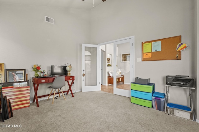 recreation room featuring french doors, a high ceiling, carpet flooring, a desk, and a ceiling fan