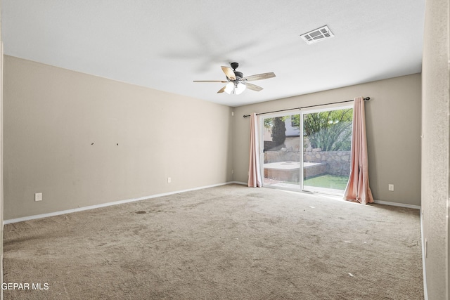 carpeted empty room featuring visible vents, baseboards, and ceiling fan