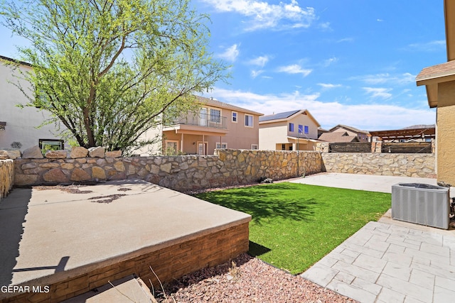view of yard featuring central AC unit, a patio area, and a fenced backyard