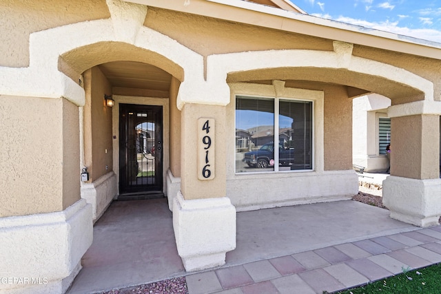property entrance featuring stucco siding