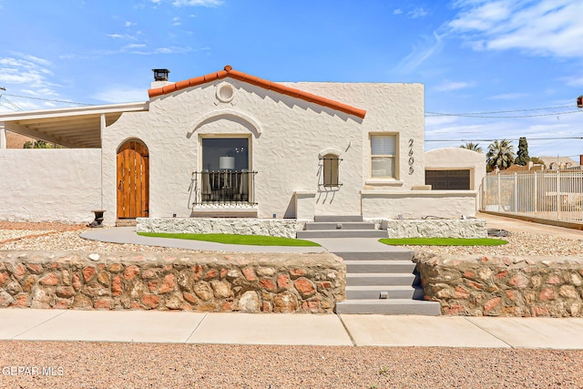 view of front of house featuring fence and stucco siding