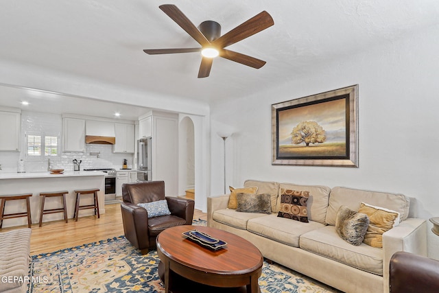 living area with recessed lighting, light wood-style flooring, and ceiling fan