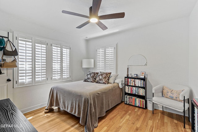 bedroom featuring baseboards, ceiling fan, and wood finished floors