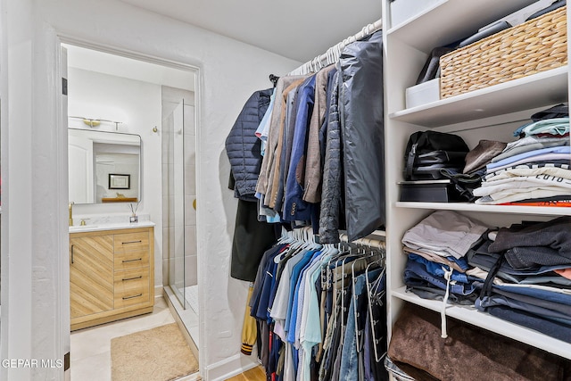 spacious closet with a sink and light tile patterned flooring