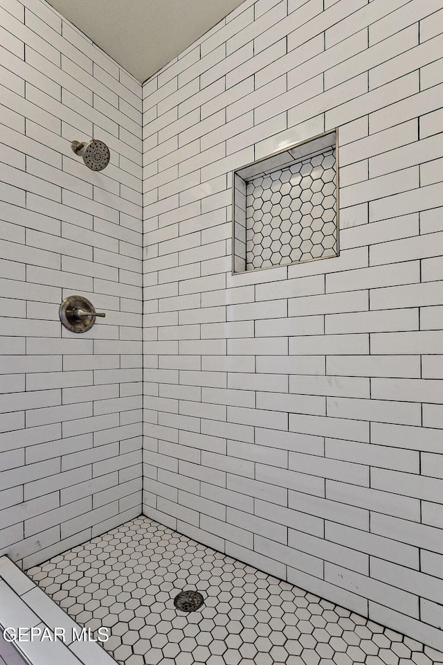bathroom with tiled shower