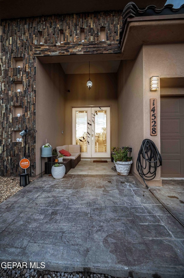 doorway to property featuring stucco siding