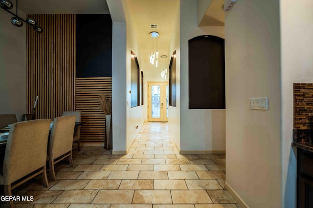 corridor featuring baseboards and visible vents