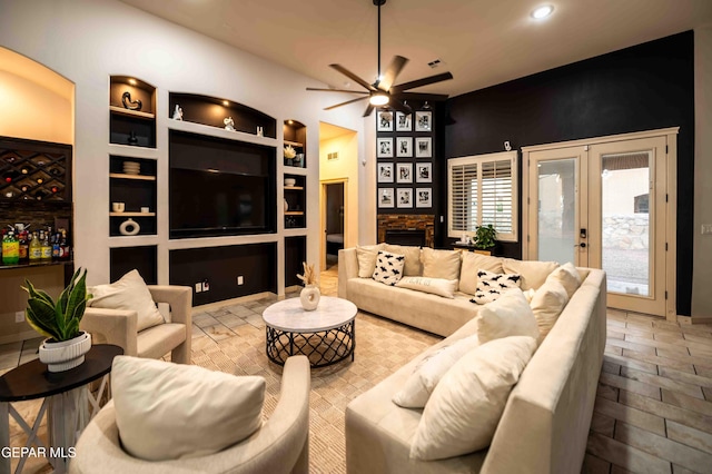 living area featuring recessed lighting, built in features, ceiling fan, and french doors