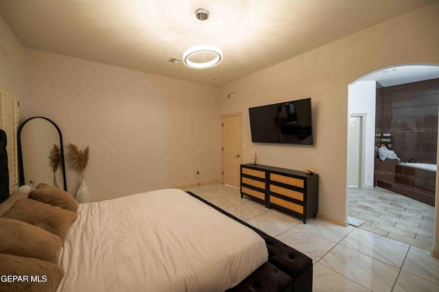 bedroom featuring arched walkways
