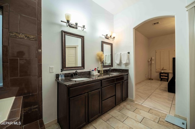 bathroom featuring a sink, visible vents, and double vanity