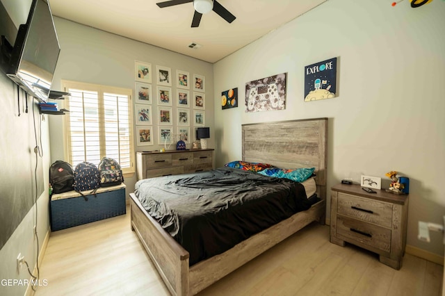 bedroom featuring ceiling fan, visible vents, and light wood finished floors