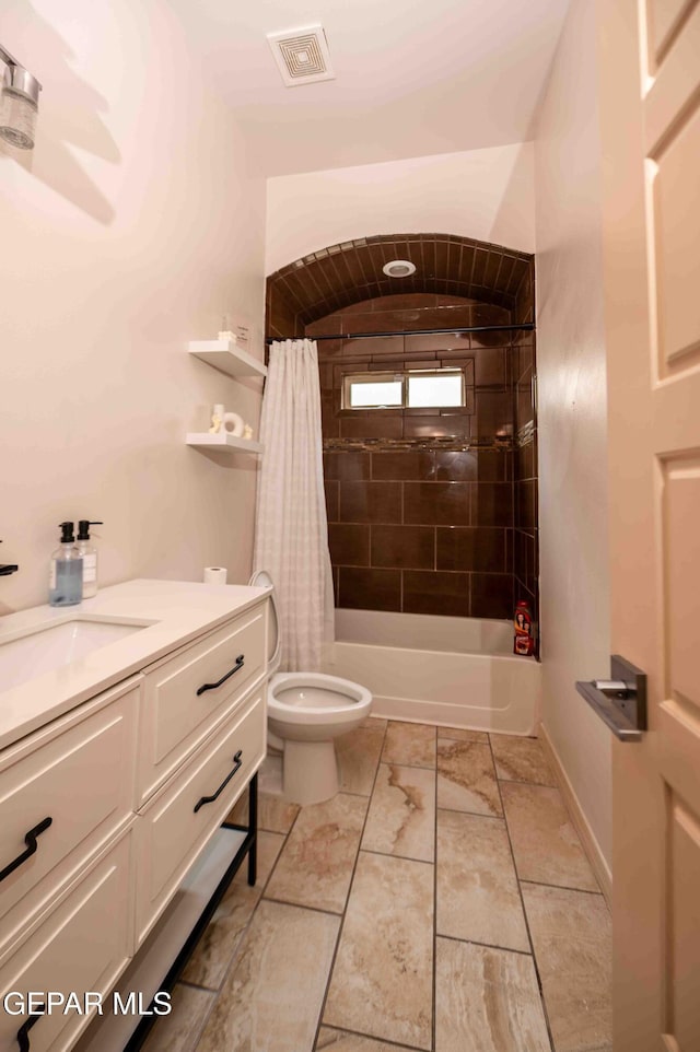 bathroom featuring shower / tub combo, toilet, vanity, and visible vents
