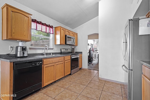 11400 Pifas Nevarez Pl, El Paso, TX 79934 - kitchen featuring a sink, lofted ceiling, arched walkways, light tile patterned floors, and appliances with stainless steel finishes