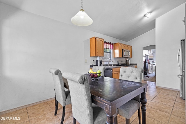 11400 Pifas Nevarez Pl, El Paso, TX 79934 - dining room with arched walkways, baseboards, light tile patterned floors, and lofted ceiling
