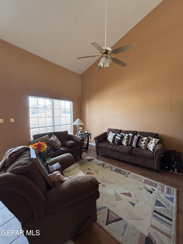 living area featuring high vaulted ceiling, ceiling fan, and wood finished floors