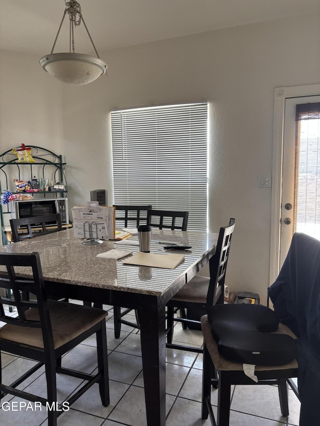 dining area with light tile patterned floors
