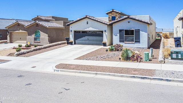 209 Epsom Dr, El Paso, TX 79928 - mediterranean / spanish home with a garage, a tiled roof, concrete driveway, and stucco siding