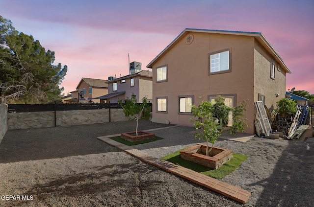 back of property with stucco siding, a patio area, and a fenced backyard