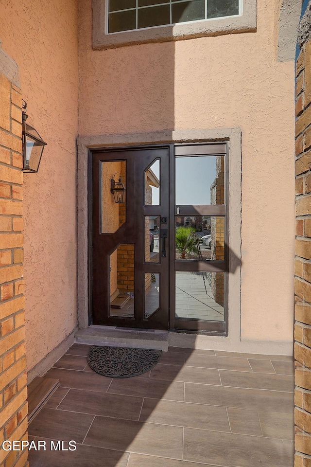 doorway to property with stucco siding
