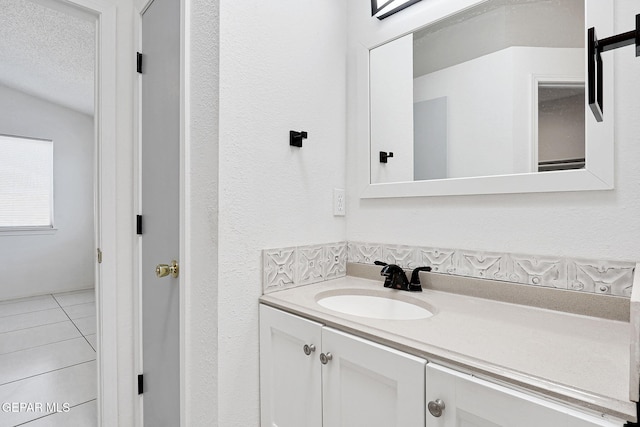 bathroom featuring tile patterned floors, vanity, and a textured ceiling