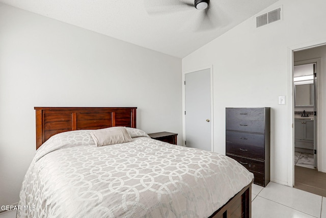 bedroom with lofted ceiling, ceiling fan, a sink, visible vents, and light tile patterned flooring