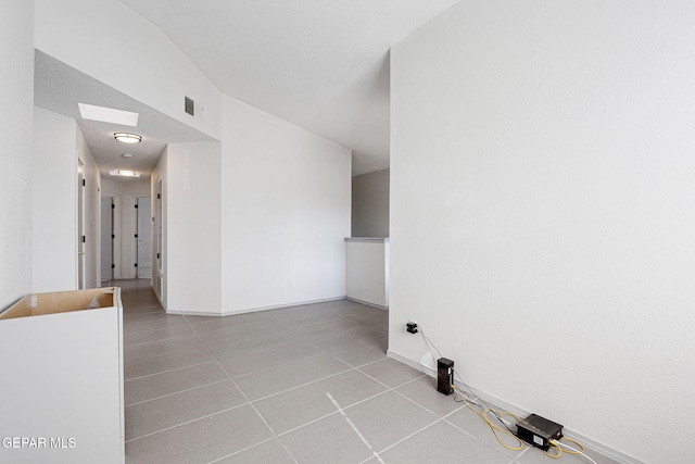 clothes washing area featuring baseboards, visible vents, and tile patterned floors