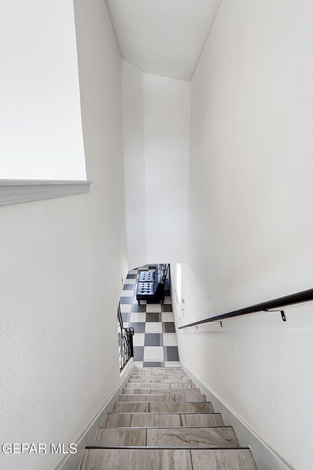 staircase with tile patterned floors