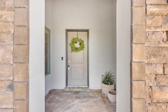 view of exterior entry with stone siding