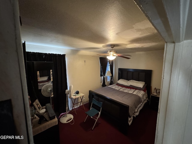 bedroom featuring a ceiling fan, carpet flooring, and a textured ceiling