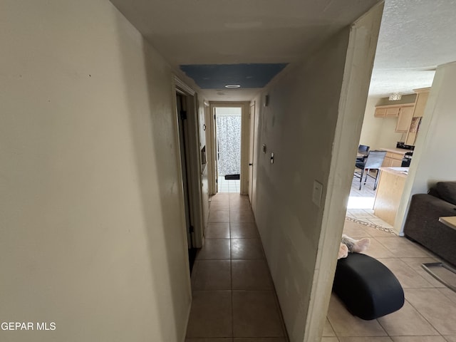 corridor featuring light tile patterned floors