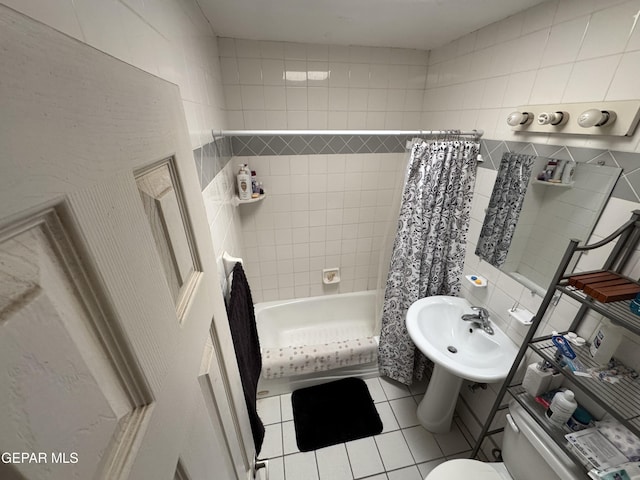 full bathroom featuring shower / bath combo, a sink, tile walls, toilet, and tile patterned flooring