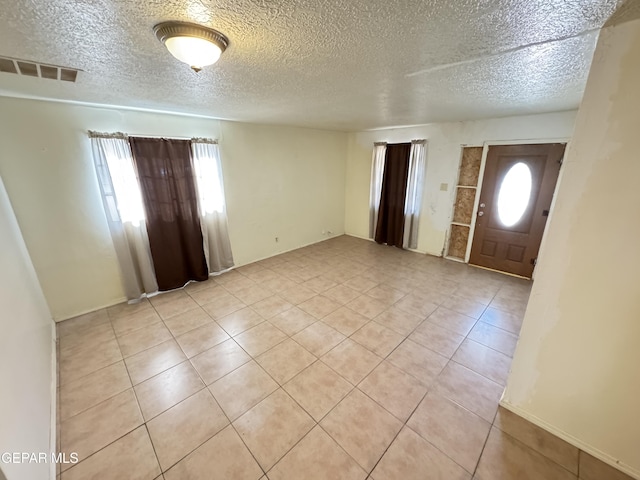 5013 Vulcan Ave, El Paso, TX 79904 - foyer with light tile patterned floors and a textured ceiling