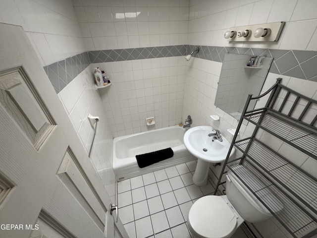 5013 Vulcan Ave, El Paso, TX 79904 - full bath with toilet, tile walls, tile patterned floors, tub / shower combination, and a sink